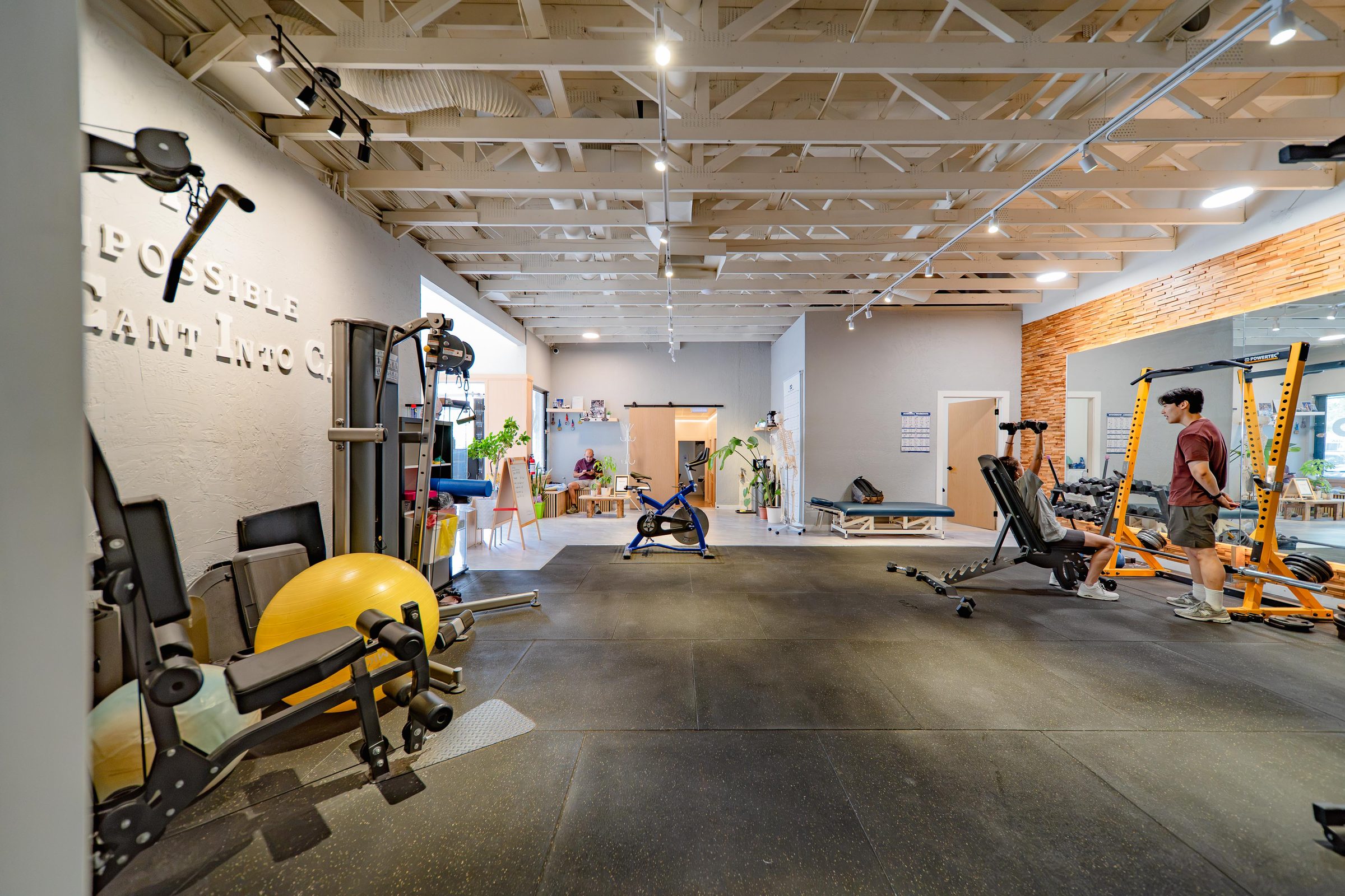The training floor at Able Wellness, with treatment rooms and reception behind it